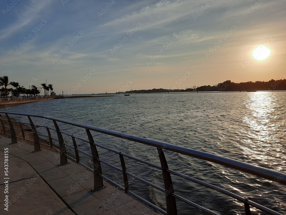 Beautiful sunset at Jeddah, Corniche. The Jeddah Corniche, also known as the Jeddah Waterfront, is a coastal area of the city of Jeddah, Saudi Arabia. Located along the Red Sea.