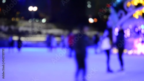 Wallpaper Mural Blurred abstract background. Many people skating on open-air ice rink, decorated large Christmas New Year tree on winter night. New Year Christmas holidays celebrate. Blurry colorful holidays backdrop Torontodigital.ca