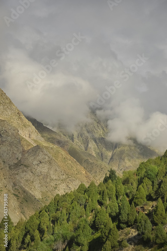 Dry mountain covered with clouds. Combination of dry mountain and green mountain in Darcha, Lahaul and Spiti, Himachal Pradesh, India  photo