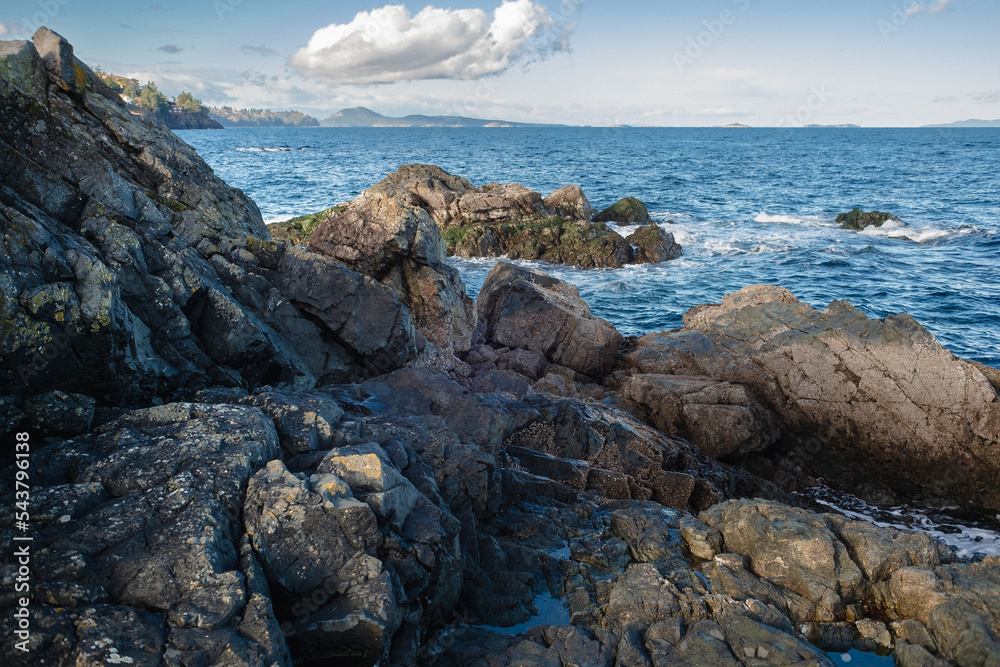 Looking north up the Strait of Georgia from the rocky outcrop of the spit at Neck Point Park, Nanaimo, British Columbia, Canada on a sunny day in November.