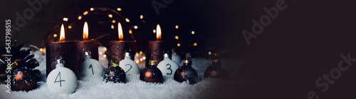 Christmas background, decoration - four brown burning advent candles with number in snow