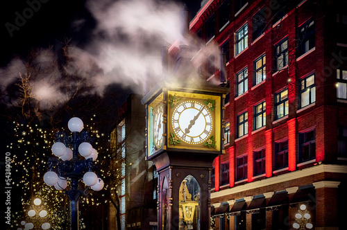 Famous Steam Clock in Gastown at night during the Christmas season. Historic downtown of Vancouver, Canada