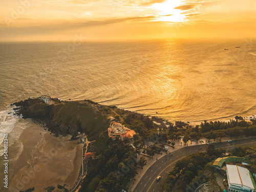 Nghinh Phong cape in Vung Tau, Vietnam. View from above with waves and beautiful cinematic sunset sky. photo