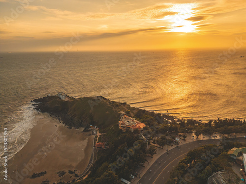 Nghinh Phong cape in Vung Tau, Vietnam. View from above with waves and beautiful cinematic sunset sky. photo