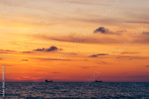 Sea horizon with ships at dusk photo