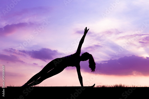 Slim girls warm up with yoga in the sunset glow