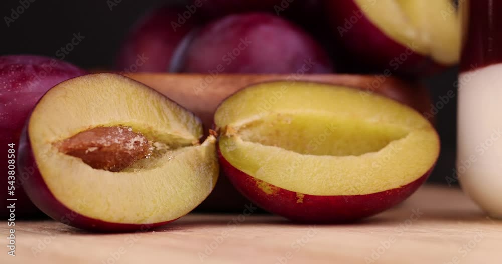 Ripe plum cut into pieces, fresh sour plum divided into half Stock Video Adobe Stock