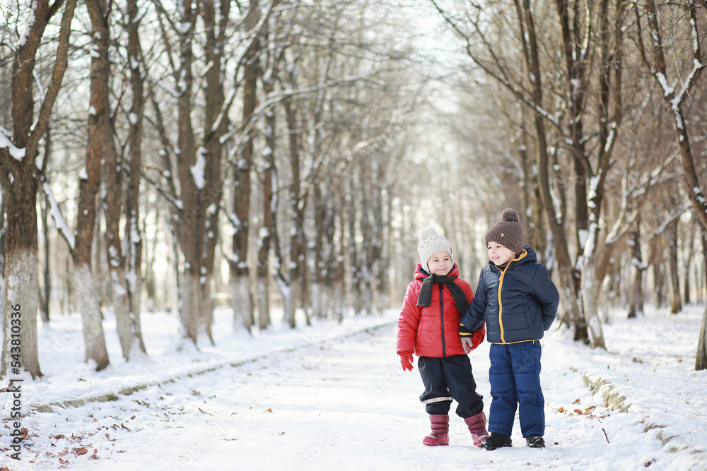 Children in winter park play Children in winter park play