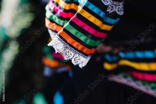 Typical Jalisco costume for woman : jalisciense dress with slats. Close-up, mexican folklore background
