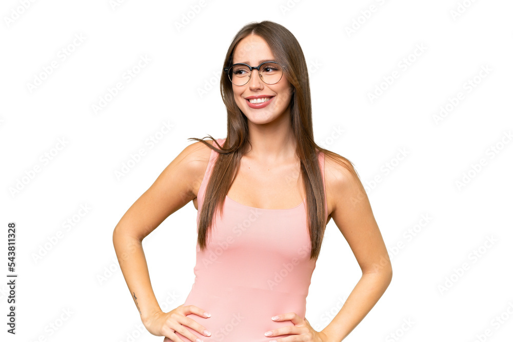 Young pretty caucasian woman over isolated background posing with arms at hip and smiling Young pretty caucasian woman over isolated background posing with arms at hip and smiling