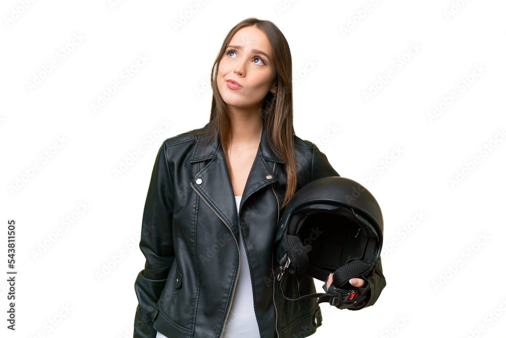Young pretty caucasian woman with a motorcycle helmet over isolated background and looking up Young pretty caucasian woman with a motorcycle helmet over isolated background and looking up