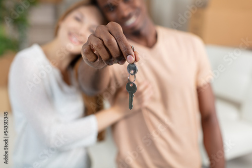 excited young family show keys to own home photo