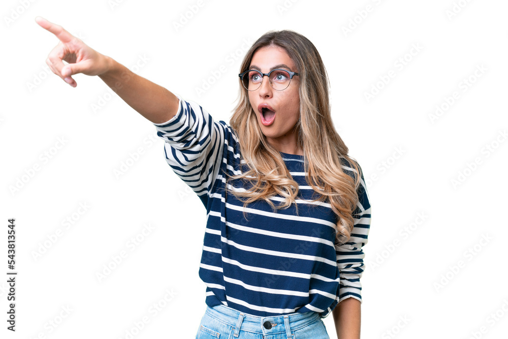 Young Uruguayan woman over isolated background pointing away Young Uruguayan woman over isolated background pointing away
