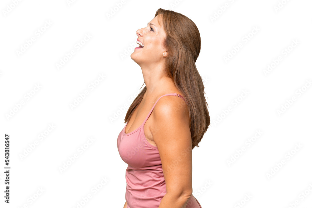 Middle-aged caucasian woman over isolated background laughing in lateral position Middle-aged caucasian woman over isolated background laughing in lateral position