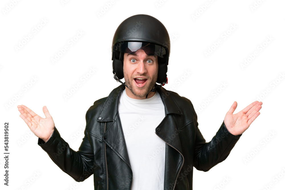 Young caucasian man with a motorcycle helmet isolated on green chroma background with shocked facial expression Young caucasian man with a motorcycle helmet isolated on green chroma background with shocked facial expression