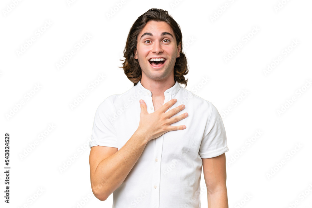Young caucasian man isolated on green chroma background surprised and shocked while looking right Young caucasian man isolated on green chroma background surprised and shocked while looking right
