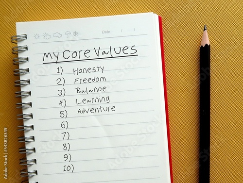 Pencil writing on notebook the list of MY CORE VALUES, to find or identify set of fundamental beliefs, ideals or practices which is direction of how to conduct life or career