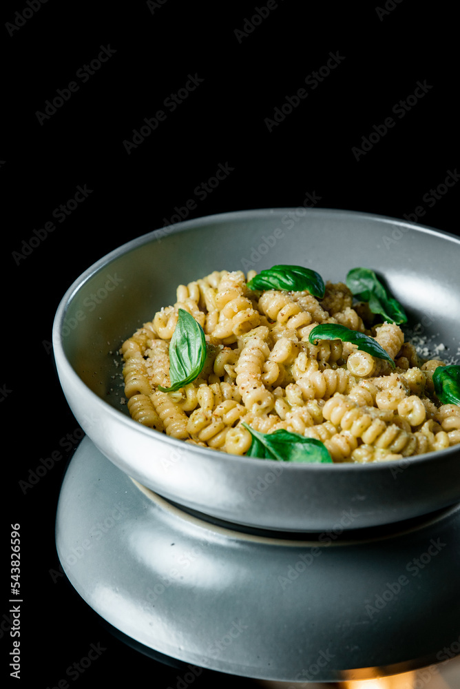 Classic homemade pasta with egg, hard parmesan cheese and cream sauce. Italian cuisine on black background Classic homemade pasta with egg, hard parmesan cheese and cream sauce. Italian cuisine on black background