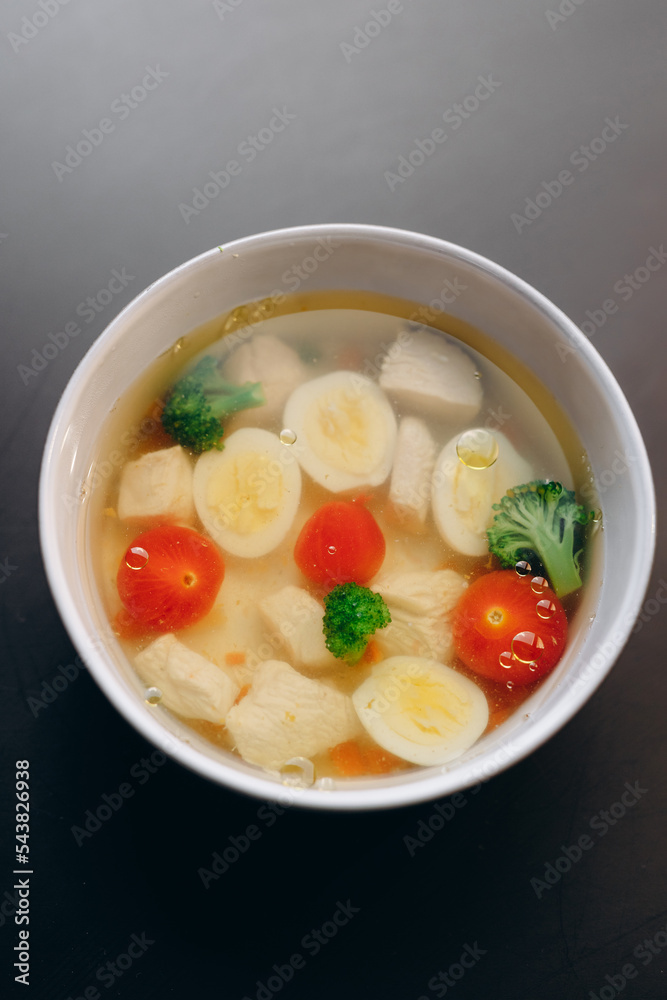 Chicken soup for children, with a boiled egg, chicken fillet, broccoli and tomatoes. Chicken soup for children, with a boiled egg, chicken fillet, broccoli and tomatoes.
