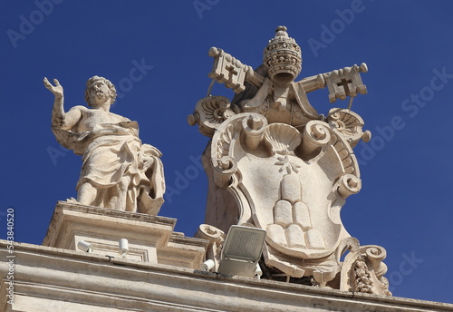 St Peter's Basilica Colonnade Statue with Sculpted Papal Coat of Arms in Rome, Italy photo