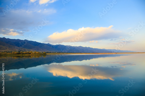 Lake in the mountains. Beautiful nature  reflection of clouds and mountains in blue water. Kyrgyzstan  Lake Issyk-Kul