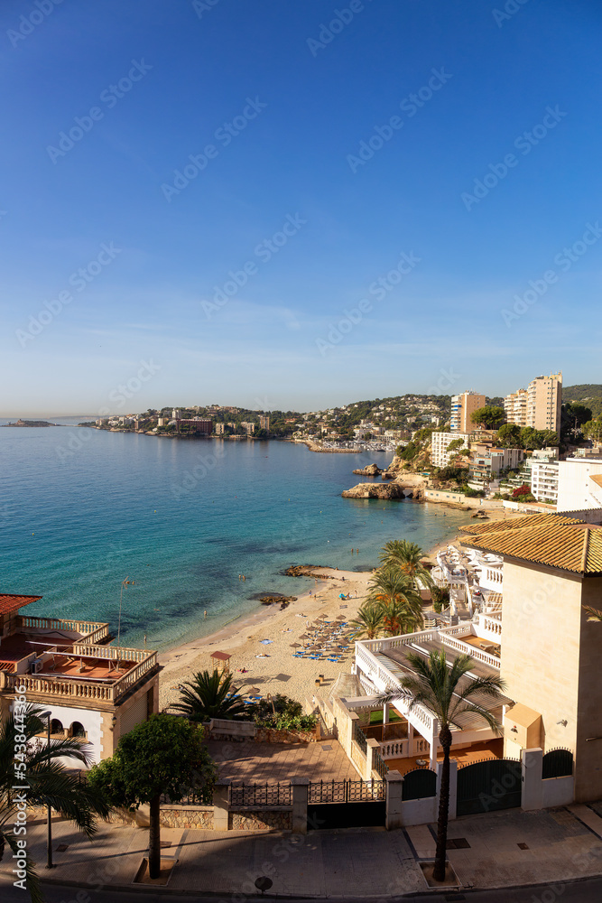 Sandy Beach, Colorful Blue Sea Water and Residential Homes on Mediterranean Coast. Palma, Balearic Islands, Spain.