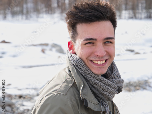 Young man in the mountain in winter with snow photo