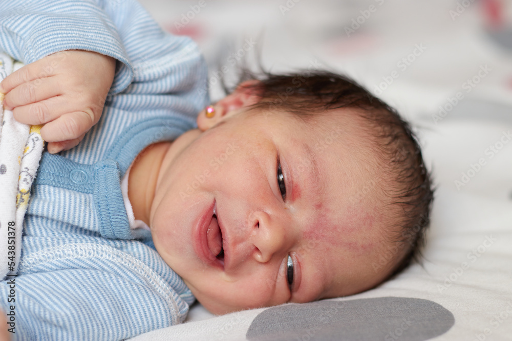 close shot of a beautiful cute girl baby in the first time of her life. adorable girl baby in a sunny bedroom. newborn cute girl relaxing on bed close shot of a beautiful cute girl baby in the first time of her life. adorable girl baby in a sunny bedroom. newborn cute girl relaxing on bed