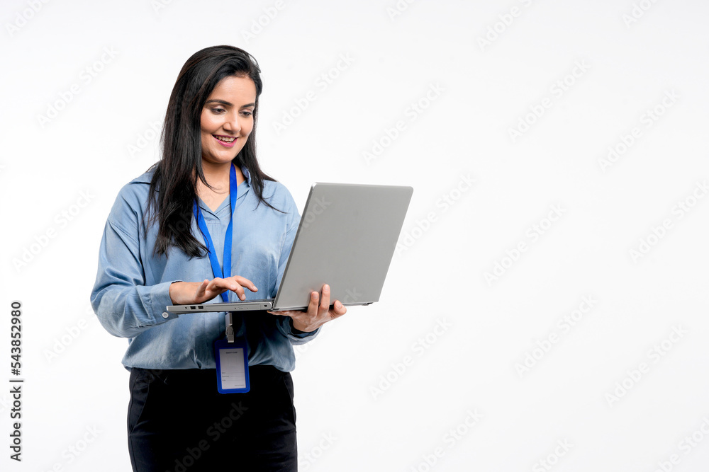 Indian businesswoman or employee using laptop on white background. Indian businesswoman or employee using laptop on white background.