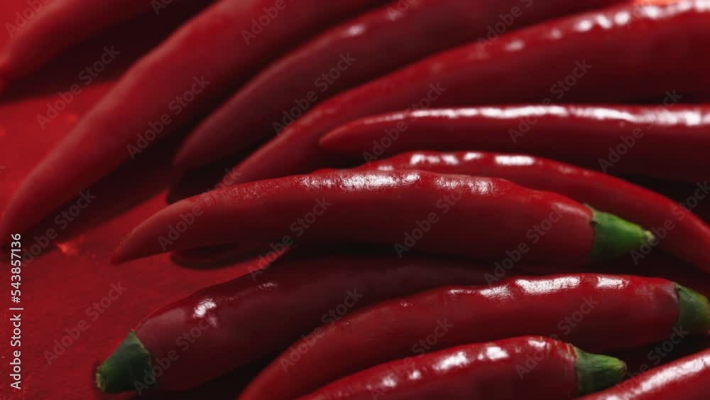red chili peppers rotate in a circle on a red plate red chili peppers rotate in a circle on a red plate