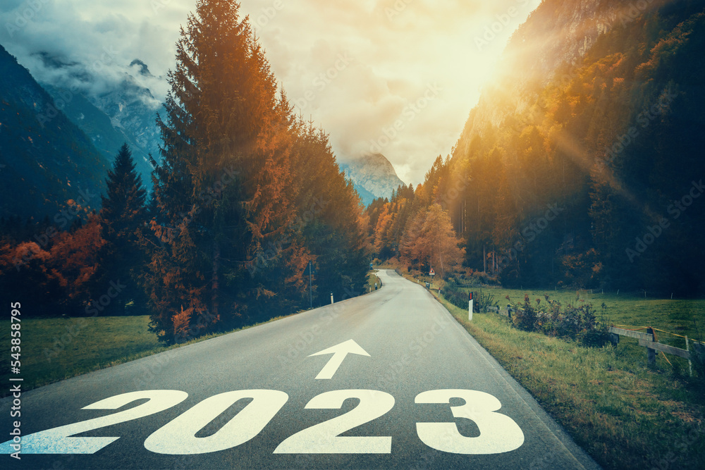 2023 New Year road trip travel and future vision concept . Nature landscape with highway road leading forward to happy new year celebration in the beginning of 2023 for fresh and successful start . - obrazy, fototapety, plakaty 
