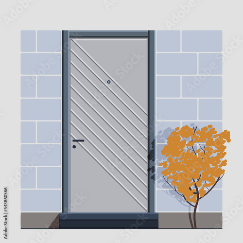 The entrance door is gray in color with an oblique line design, a handle and a lock and a peephole. Stairs to the door and a concrete wall with a tree next to it. Isolated on gray background..