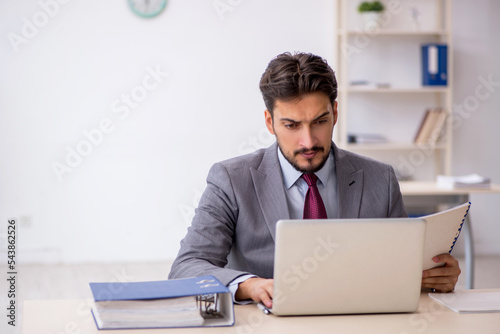 Young male employee working in the office