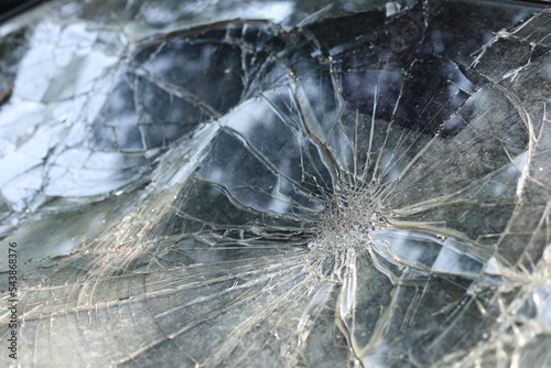 Old car glass cracked. Broken windshield surface damaged in severe accident with copy space. Selective focus
