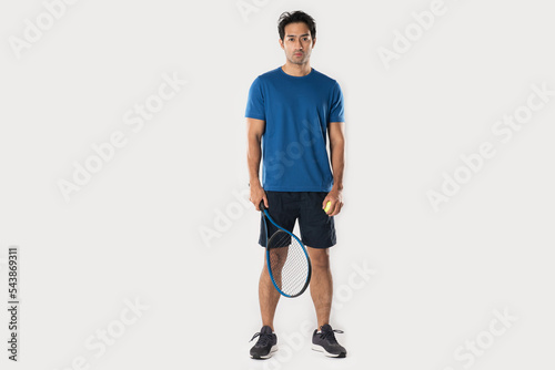 A male tennis player holding a tennis racket with a determined expression and eyes. © Naypong Studio
