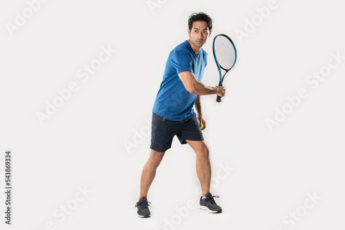 Male tennis player playing tennis with striving for victory gesture. © Naypong Studio