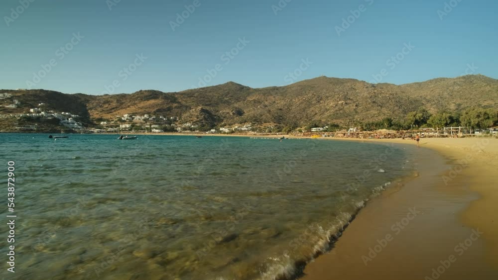 Walking down the popular Mylopotas beach of Ios Greece Walking down the popular Mylopotas beach of Ios Greece