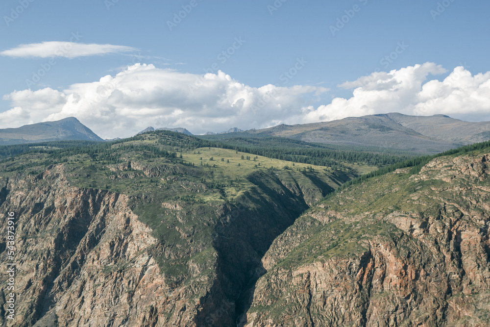 Atmospheric view of a mountain valley divided by a huge crevice