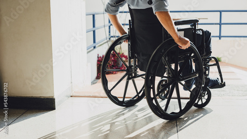 Disabled man sitting in a wheelchair. People with disabilities can access anywhere in public place with wheelchair that make them independent in transportation. photo