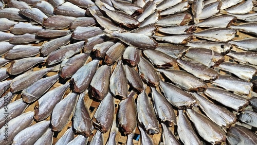 Dried fish laying on the bamboo basket.