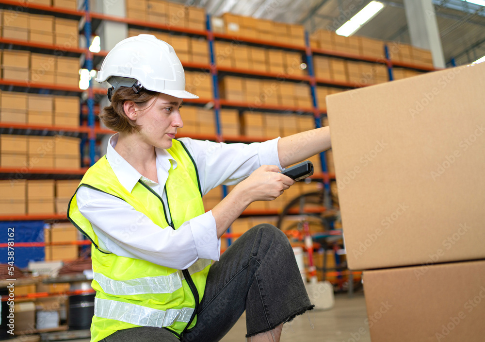 A female worker is working to inspect and pack goods in a warehouse. A female worker is working to inspect and pack goods in a warehouse.