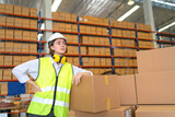A female worker is working to inspect and pack goods in a warehouse.