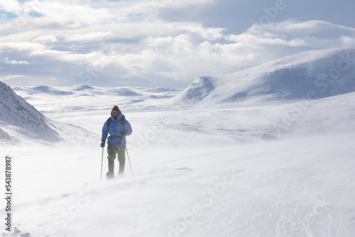 Snow shoe hiking on a sunny day in the mountains of Dovrefjell National Park