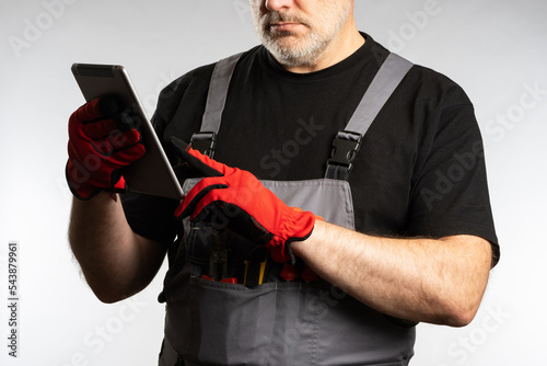 Tablet in hands worker. Man...