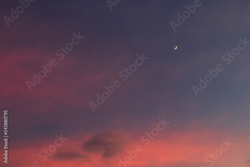 Crescent moon on beautiful sunset sky background.