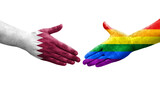 Handshake between LGBT and Qatar flags painted on hands, isolated transparent image.