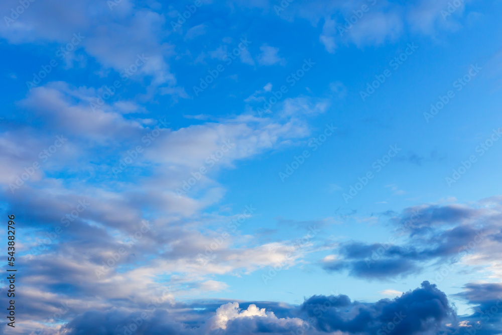 Beautiful cumulus clouds in the light blue sky
