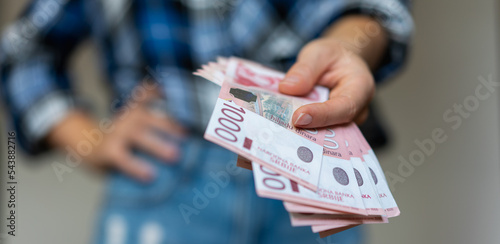 Serbian 1000 dinars banknotes cash in hand. photo