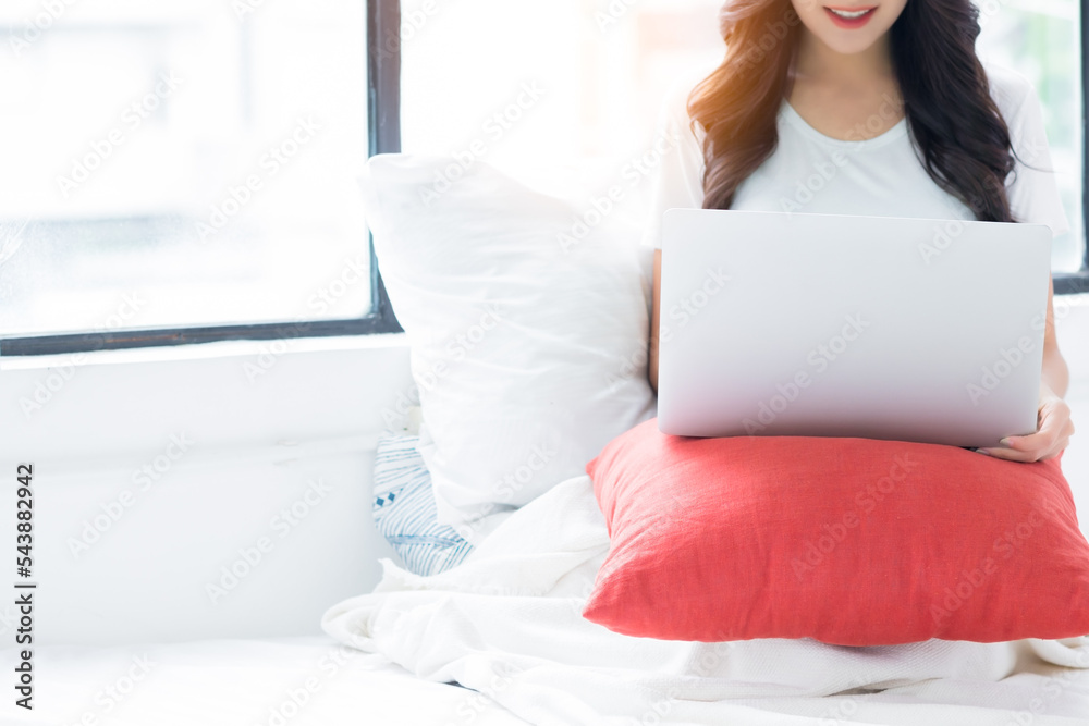 Happy woman use laptop computer sitting in bed at home Happy girl planning for booking online vacation holiday on website at home Lifestyle beautiful Asian girl relax enjoy technology wireless Happy woman use laptop computer sitting in bed at home Happy girl planning for booking online vacation holiday on website at home Lifestyle beautiful Asian girl relax enjoy technology wireless