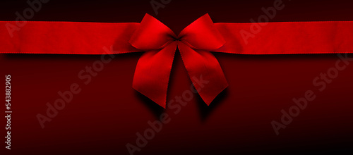 Rote Weihnachtsscheife auf rotem Hintergrund